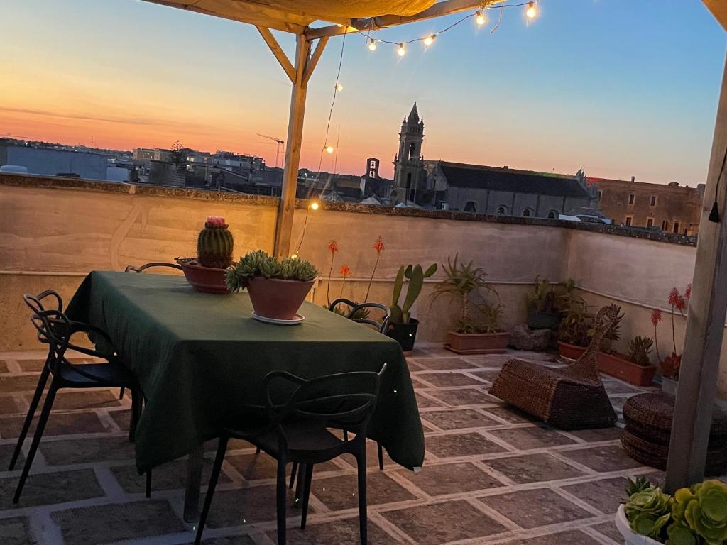 a table and chairs on a patio with a view at Oasi nel Salento in Tricase