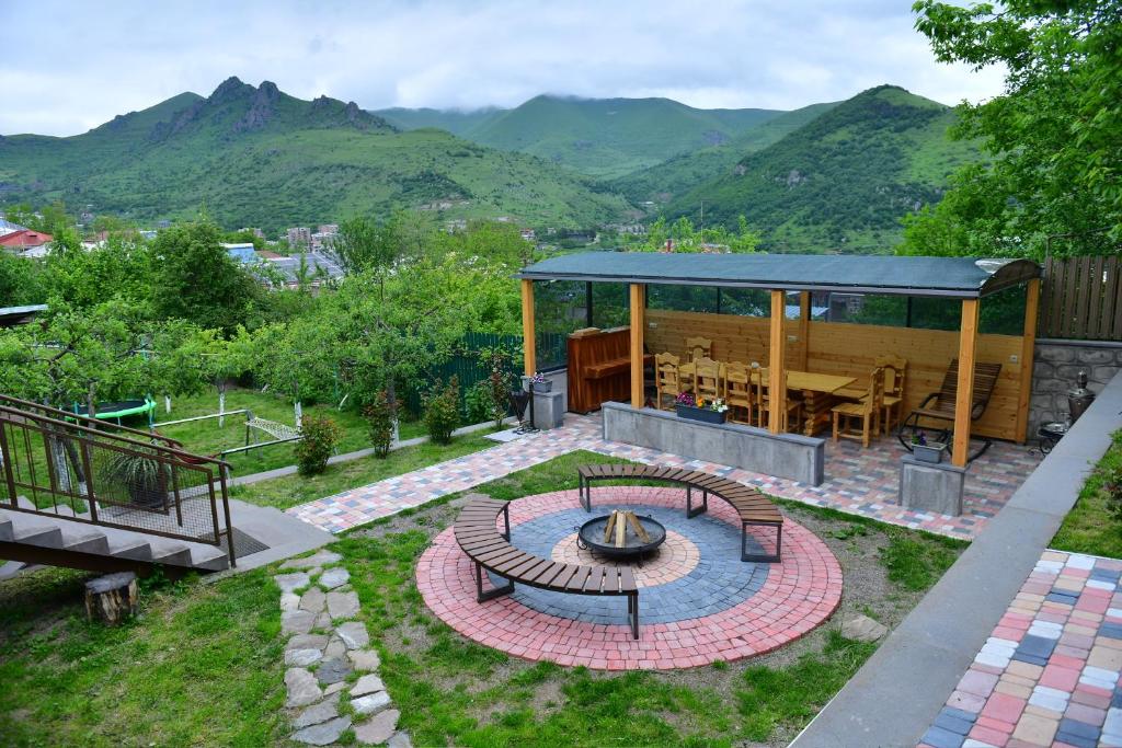 a backyard with a fire pit and a gazebo at Hayi Tun Guest House in Goris