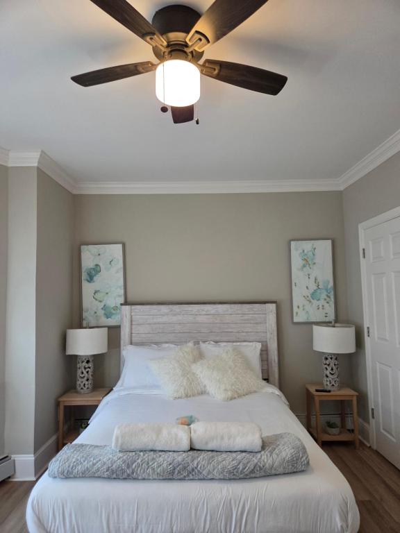 a bedroom with a bed with a ceiling fan at Shore Getaway 2 in Atlantic City