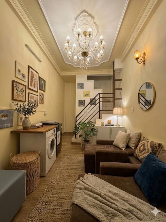 a living room with a couch and a chandelier at The New Chapter Hostel in Ho Chi Minh City