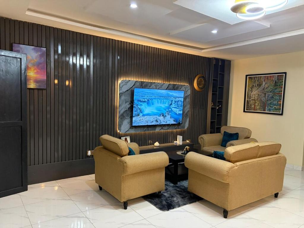 a waiting room with two chairs and a table at Modern 2 BR apartment in Lekki