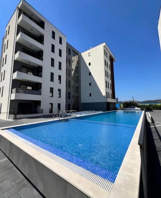 a swimming pool in front of two buildings at Apartment by Bar in Bar