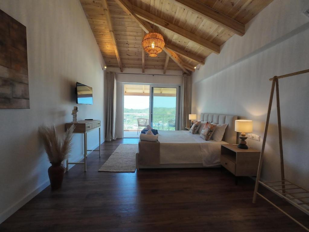 a bedroom with a bed and a table with a lamp at Lovely Sea View Apartments & Junior Suites in Himare