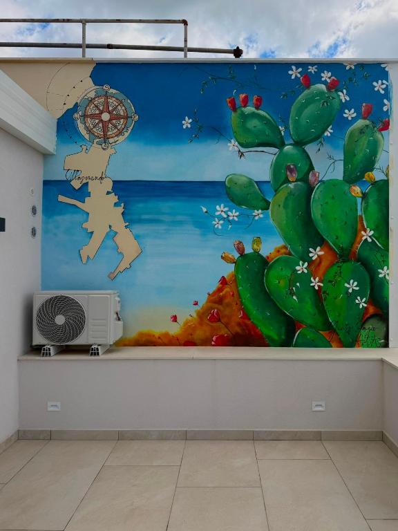 a wall mural in a room with a cactus at Al58 Casa Vacanze in Villasmundo