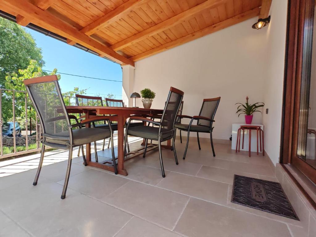 a dining room table and chairs on a patio at House RudNik in Silent Village, Island Krk in Isola Veglia