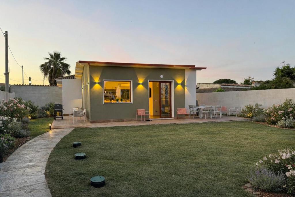 a small house with a lawn in front of it at Luce di Mare in Quartu SantʼElena