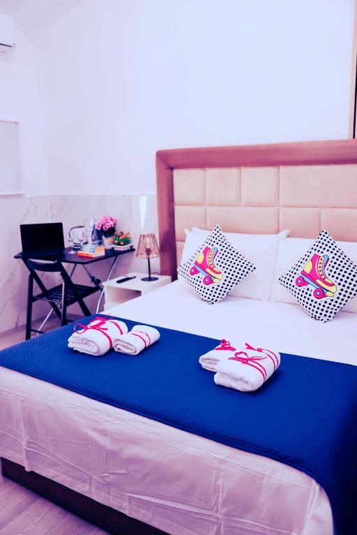 a bed with three pairs of slippers on it at Western Termini Guest House in Rome