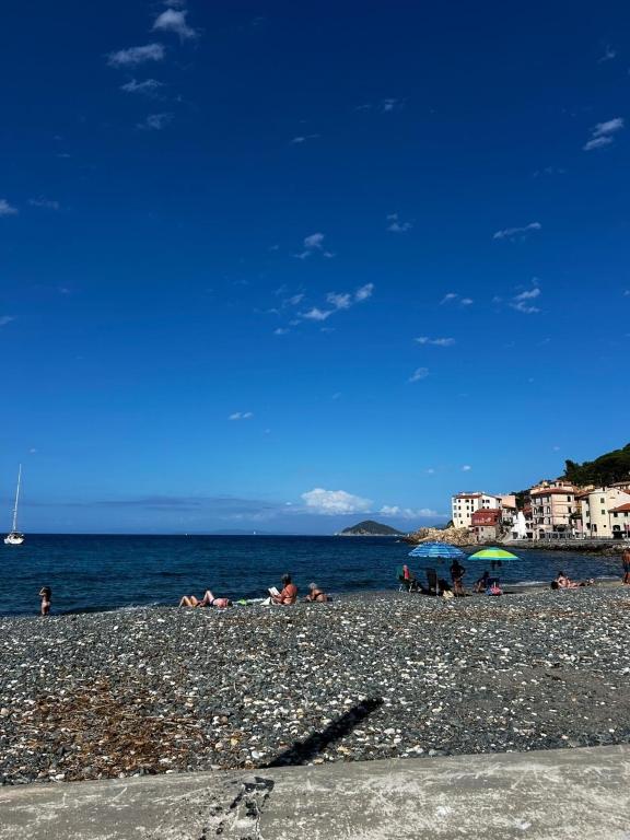 a group of people laying on a beach at Bastianina's home in Marciana Marina