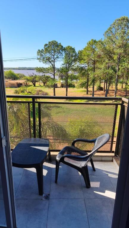 a balcony with two chairs and a bench on a porch at Los Abus in Colón