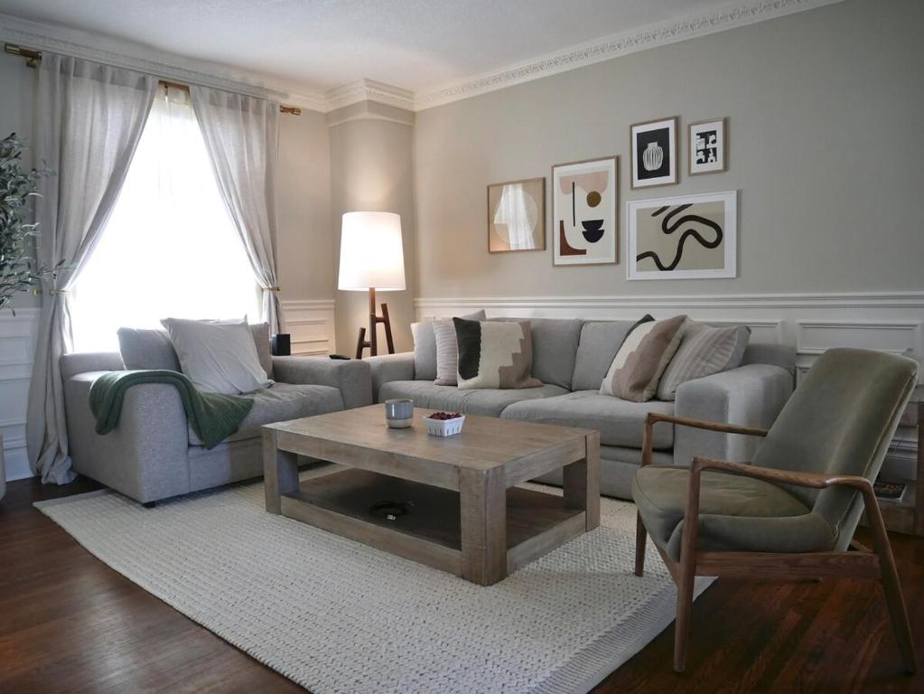 a living room with a couch and a coffee table at Modern & Spacious 1908 Home in Stratford