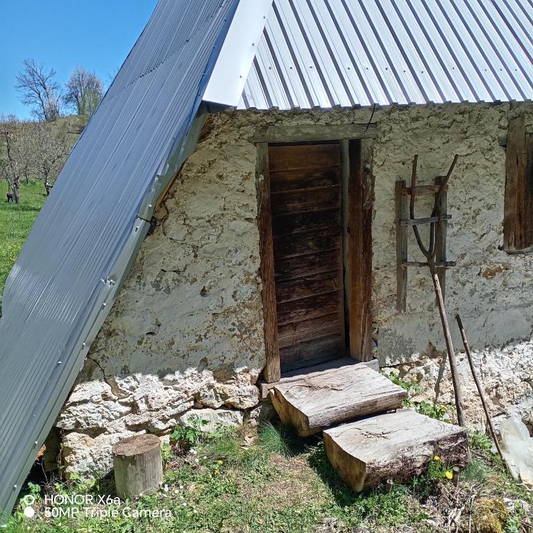 an outside view of a building with a metal roof at Djedova Zemljana kuca in Žabljak