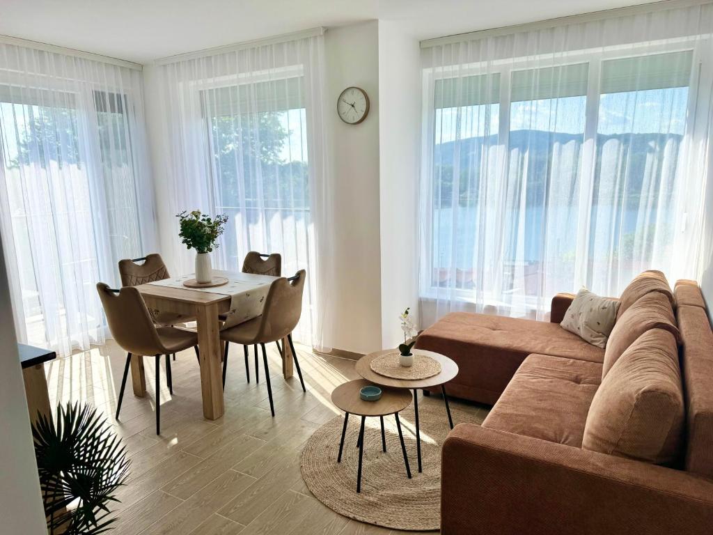 a living room with a couch and a table at Nest apartman 2 in Veliko Gradište