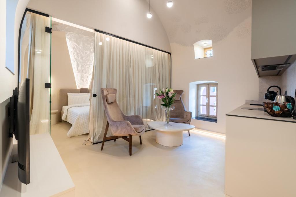 a living room with a bed and a table and chairs at Ali Baba Apartment in Mostar