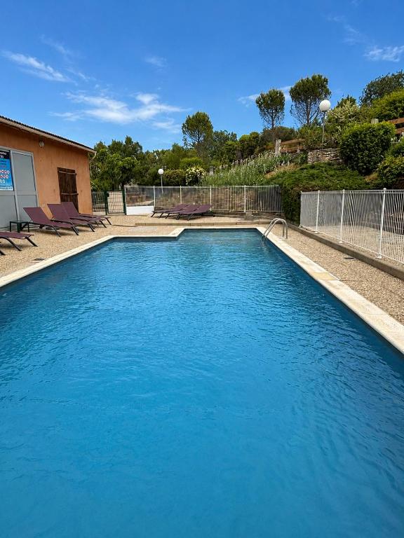 a large pool of blue water in a yard at Maison proche vallon pont d arc in Salavas