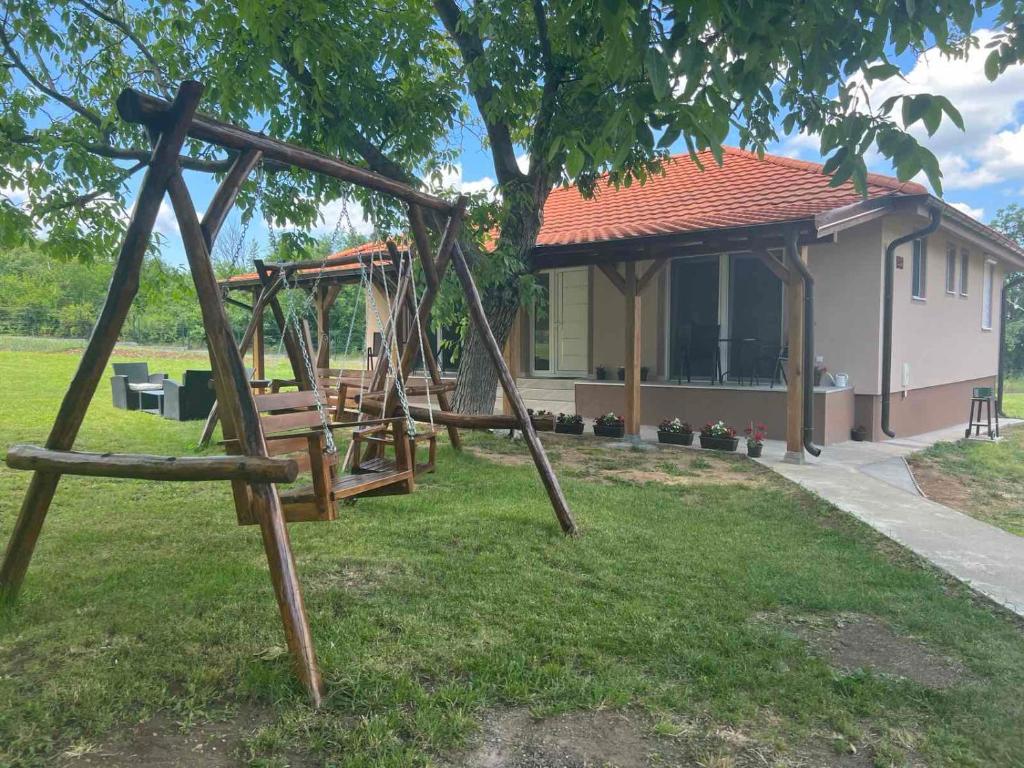 a playground in a yard next to a house at Apartmani Milojević in Boljevac
