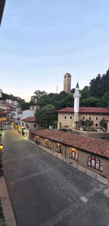 an empty street with a building and a lighthouse at Bascarsija in Ulcinj