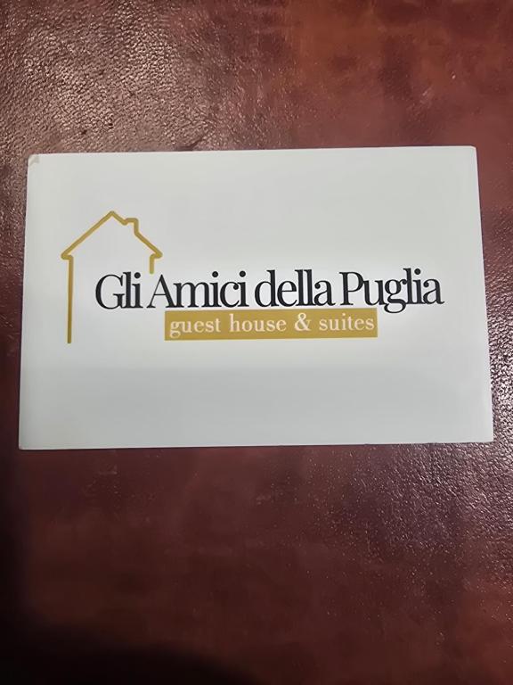 a sign for a guest house and suites at Gli Amici della Puglia 2 in Taranto
