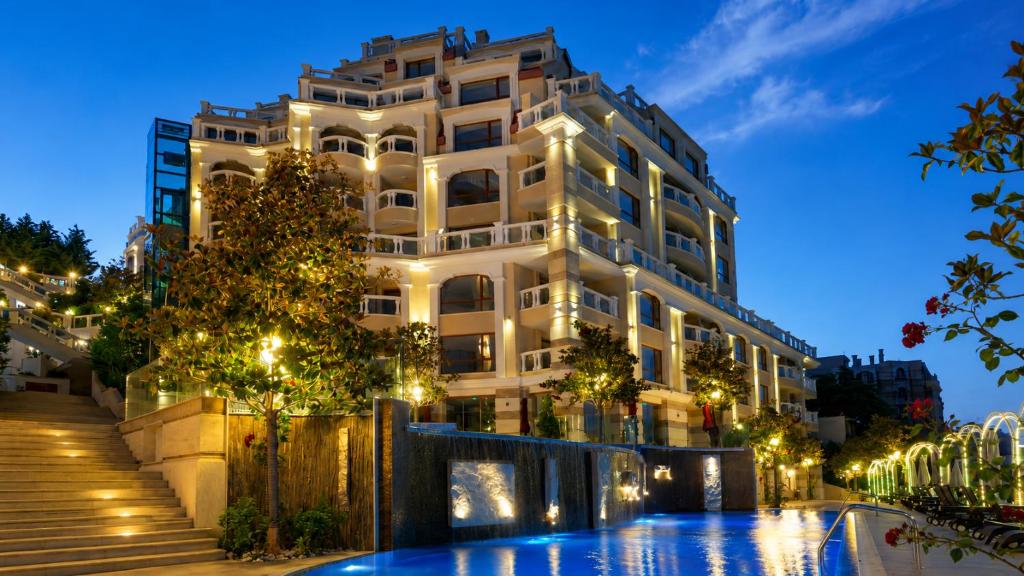 a building with a pool in front of it at Luxurious and panoramic apartments at the beach in La Mer complex in Golden Sands