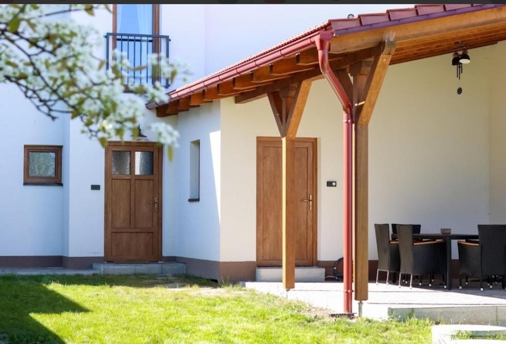 a house with a wooden door and a table at Dům U babičky in Laškov