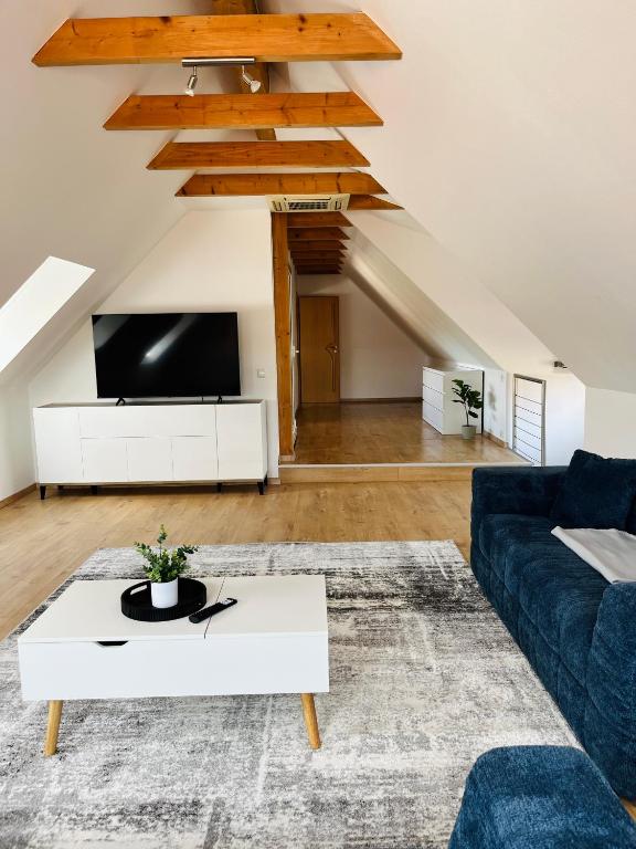 a living room with a couch and a table at Ferienhäuser Radebeul "Maisonette Klein Nizza" in Radebeul