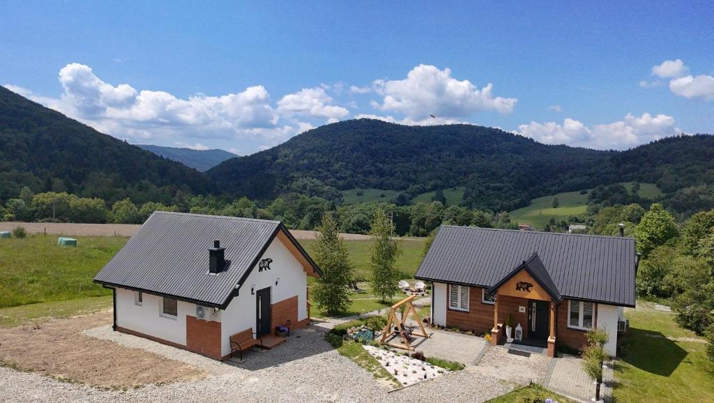 an aerial view of a house with mountains in the background at Chatka Niedźwiadka-domek na odludziu in Uście Gorlickie