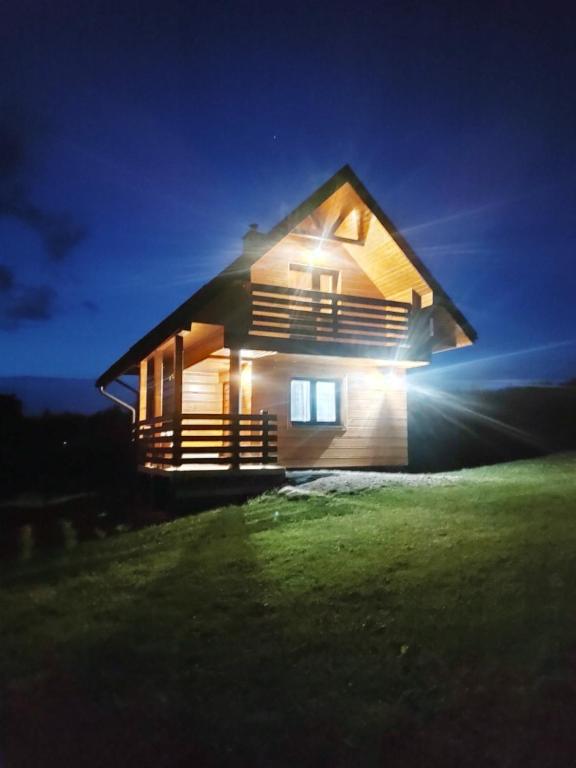 a house at night with the lights on at Domki Żaklin in Berezka