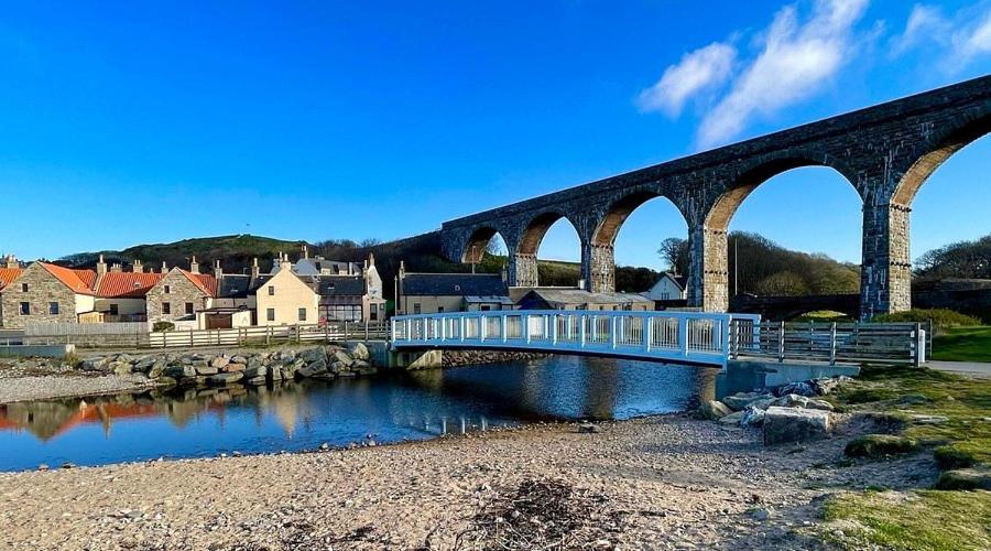 a bridge over a river with a train on it at Salt View in Cullen