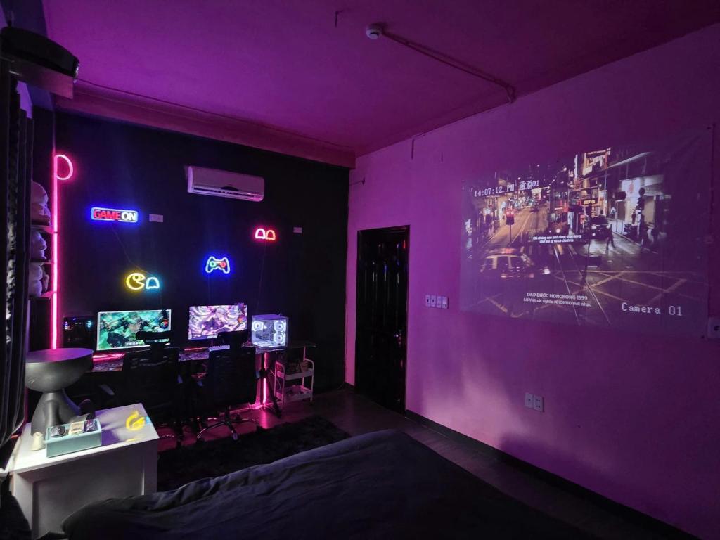 a purple room with a bed and neon lights at VV House and Cinema 2 in Quy Nhon