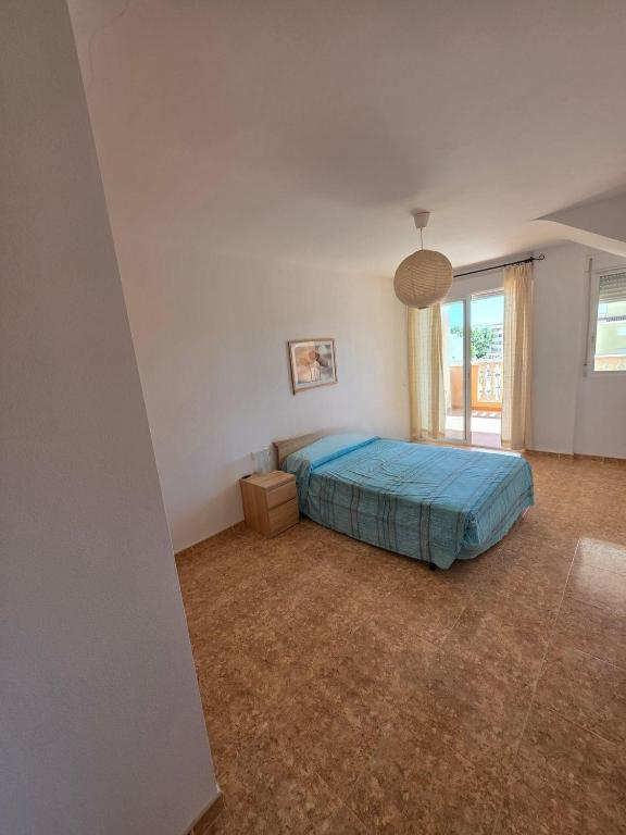 a bedroom with a bed and a large window at Durino apartment with terrace in Moncófar