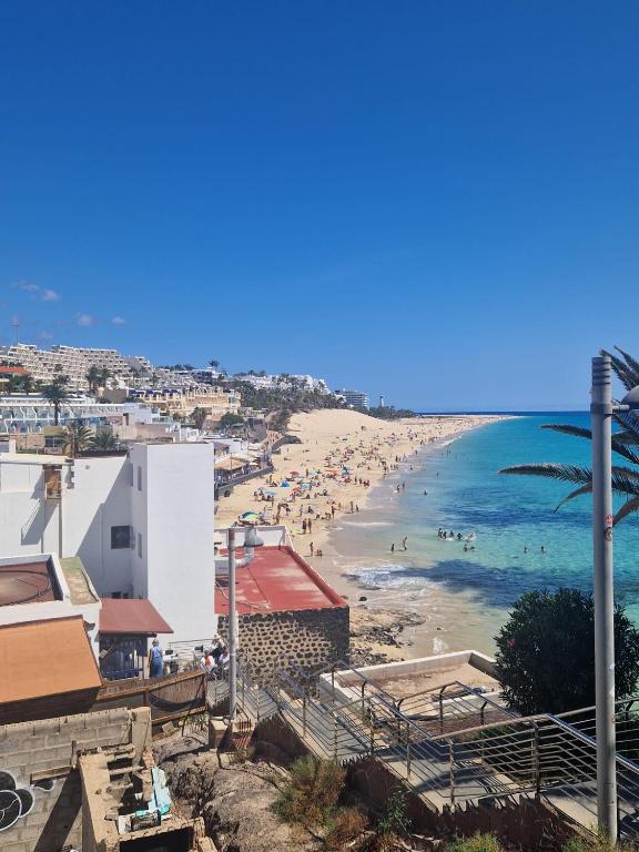 a view of a beach with people in the water at Hostal Maxorata in Morro del Jable