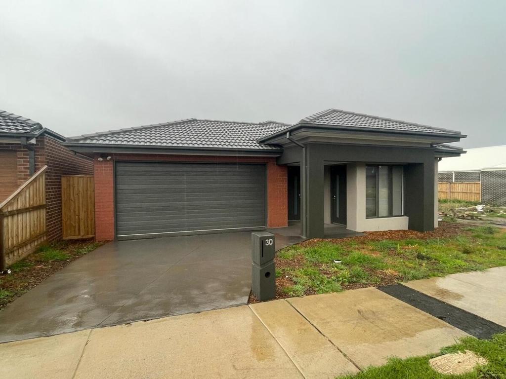 a house with a garage in front of it at Darley Retreat in Darley