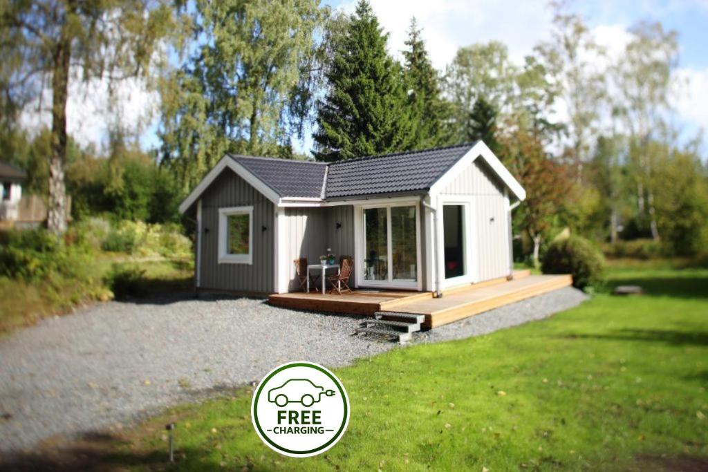 a tiny house with a deck in a yard at Landvetter House in Landvetter
