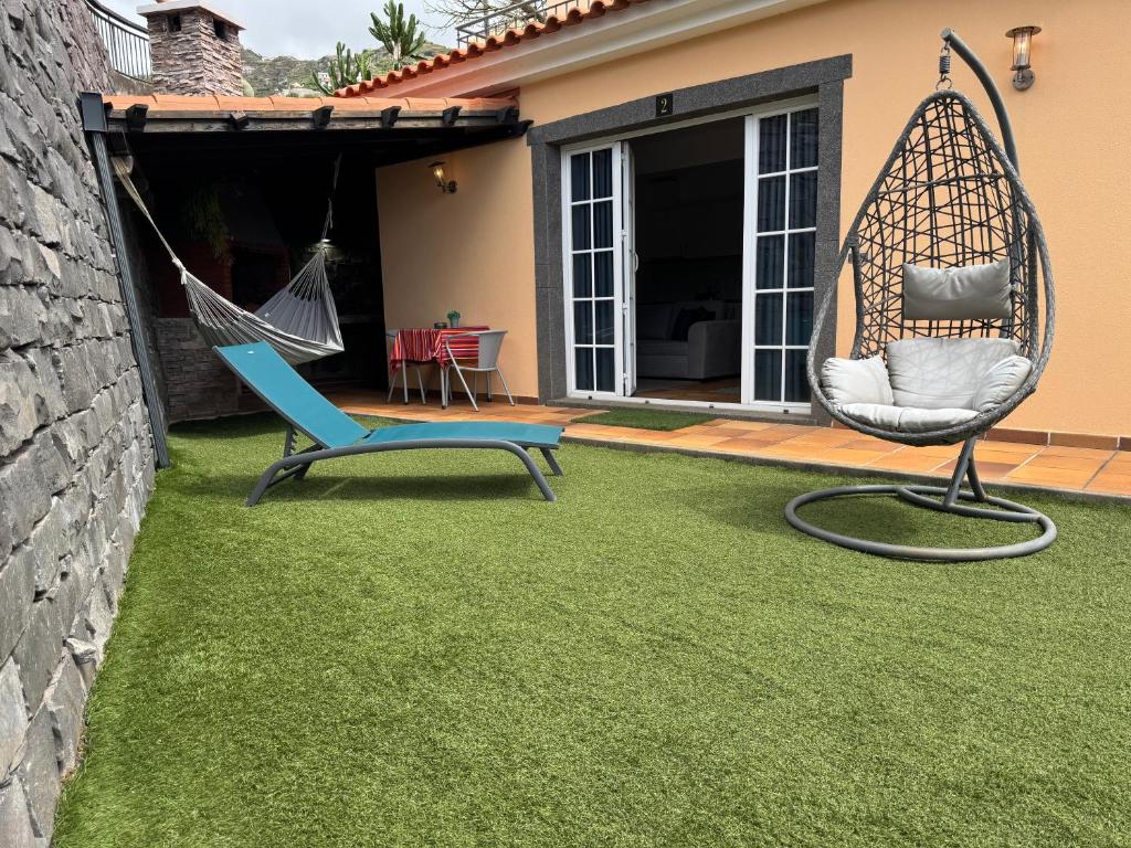 a yard with a swing and a hammock at Alforra Residence 2-Centro-Praias-Levadas in Câmara de Lobos