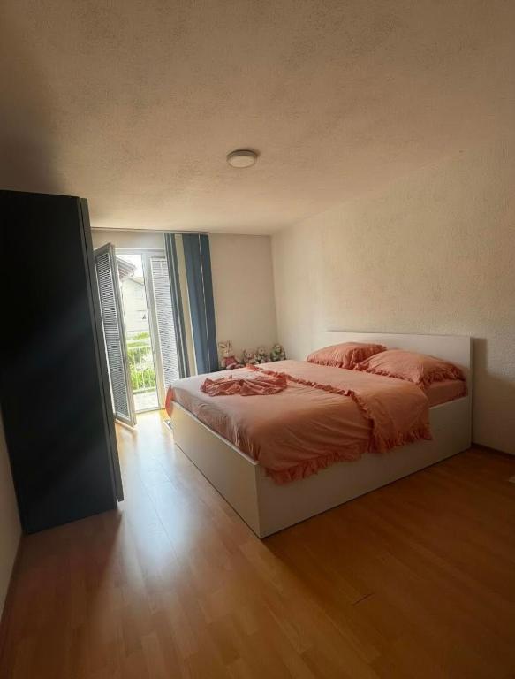 a bedroom with a bed and a large window at Apartman Leki in Sarajevo