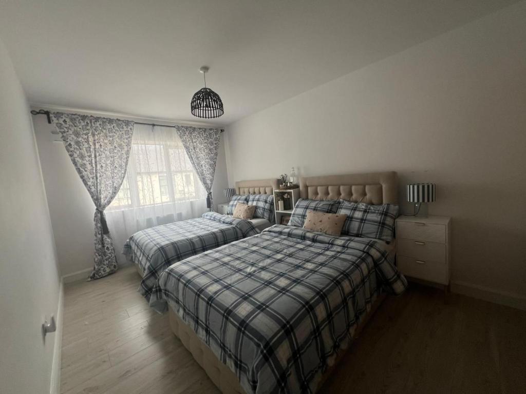 a bedroom with two beds and a window at Modern House in Dublin15, Great Location Near Dublin Airport in Tyrrelstown