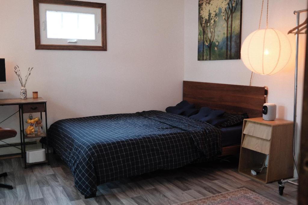 a bedroom with a bed and a table and a window at Belmont Station in Belmont