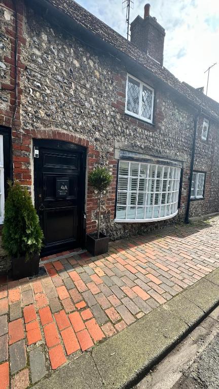 a brick house with a garage and a window at Garden View Homestay in Historic Patcham, Brighton in Brighton & Hove