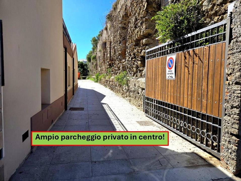 an empty street with a gate and a stone wall at Villa Castiglia - Proppro SRL - Milazzo in Milazzo