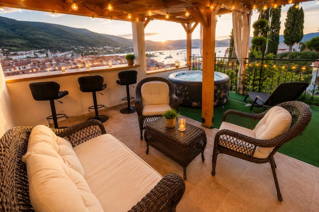 a living room with a couch and chairs and a hot tub at Panoramic view with jacuzzi in Vis