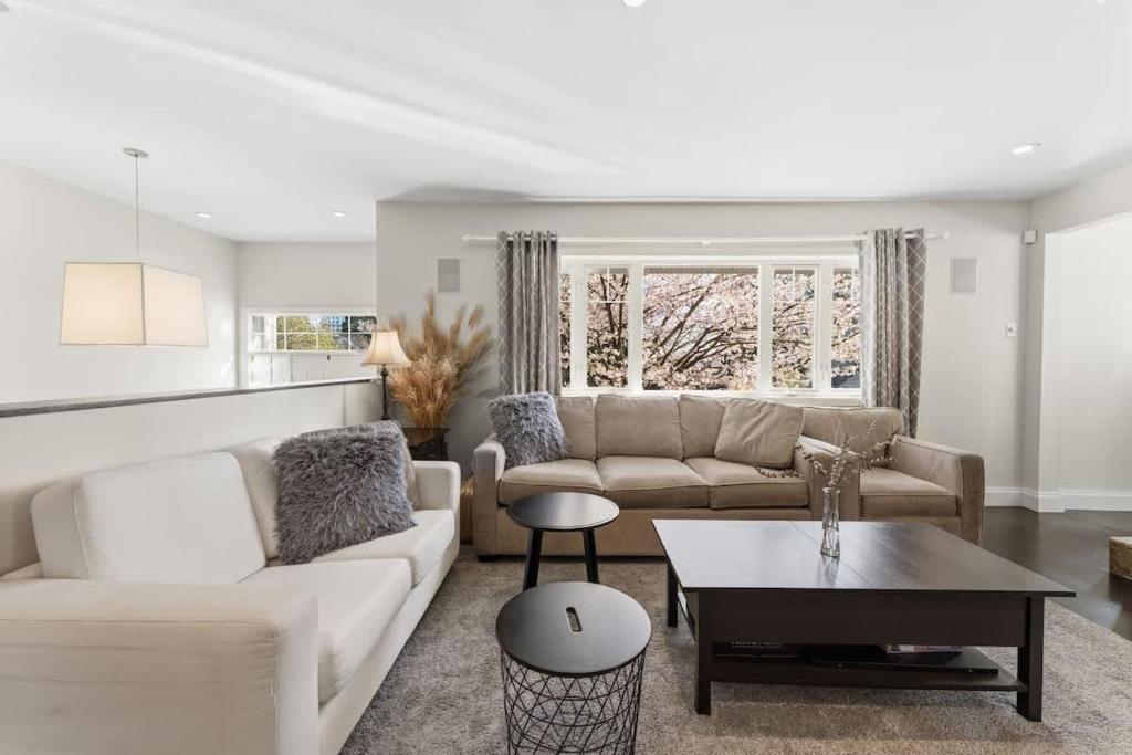 a living room with a couch and a table at Bright Coquitlam Home & Spacious Backyard in Coquitlam