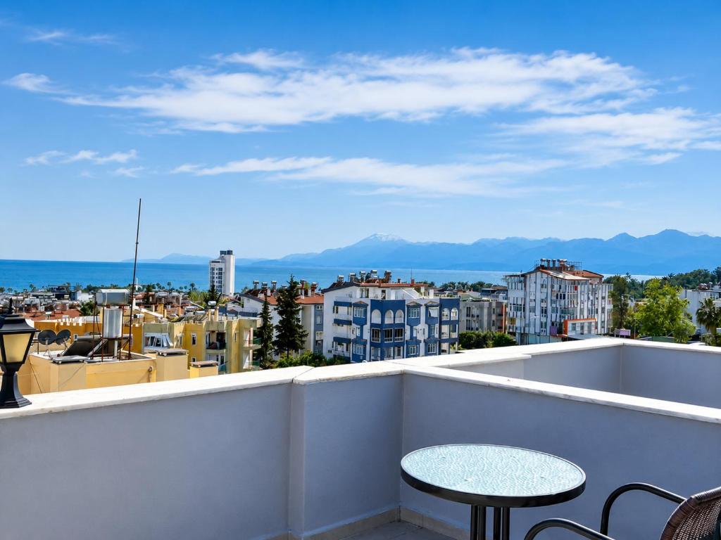 a balcony with a table and a view of a city at Luna Hotel in Antalya