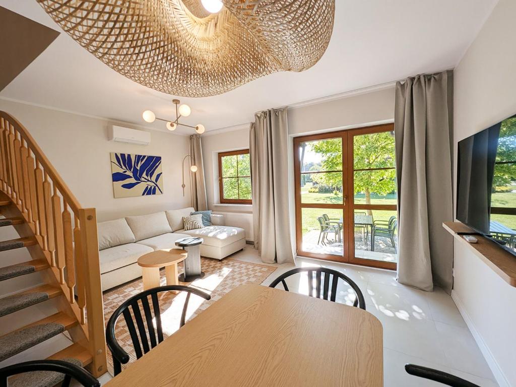 a living room with a table and a couch at Nautilus-Rowy in Rowy