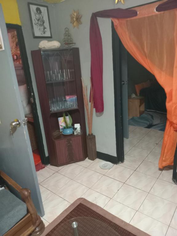 a living room with a curtain on the floor at Movement and Reposé in Clarks Town