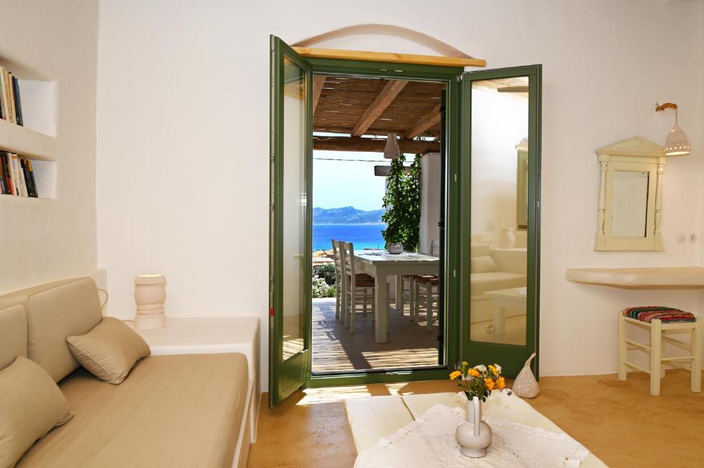 a living room with a couch and a view of the ocean at Pambelos Lodge - Apartments in Koufonisia