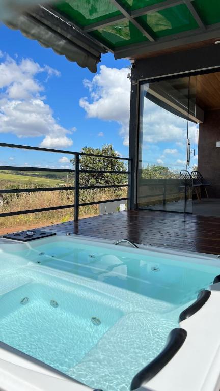 a hot tub on a deck with a view at Casa de Chame Refúgio da Serra in Brasília