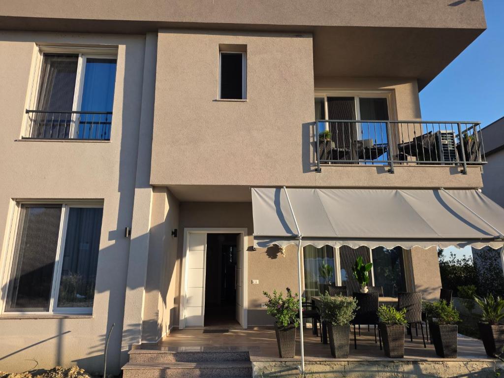 a building with a tent in front of it at Villa Gala - First Floor Apartment in Draç