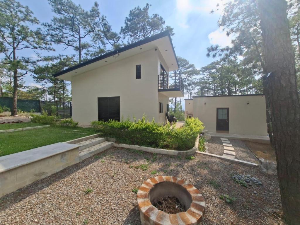 a house with a fire pit in the yard at Villa 1991 in San Ignacio