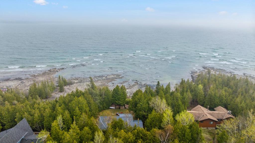 an aerial view of a house and the ocean at Rustic Waterfront Kayak Near National Park in Tobermory