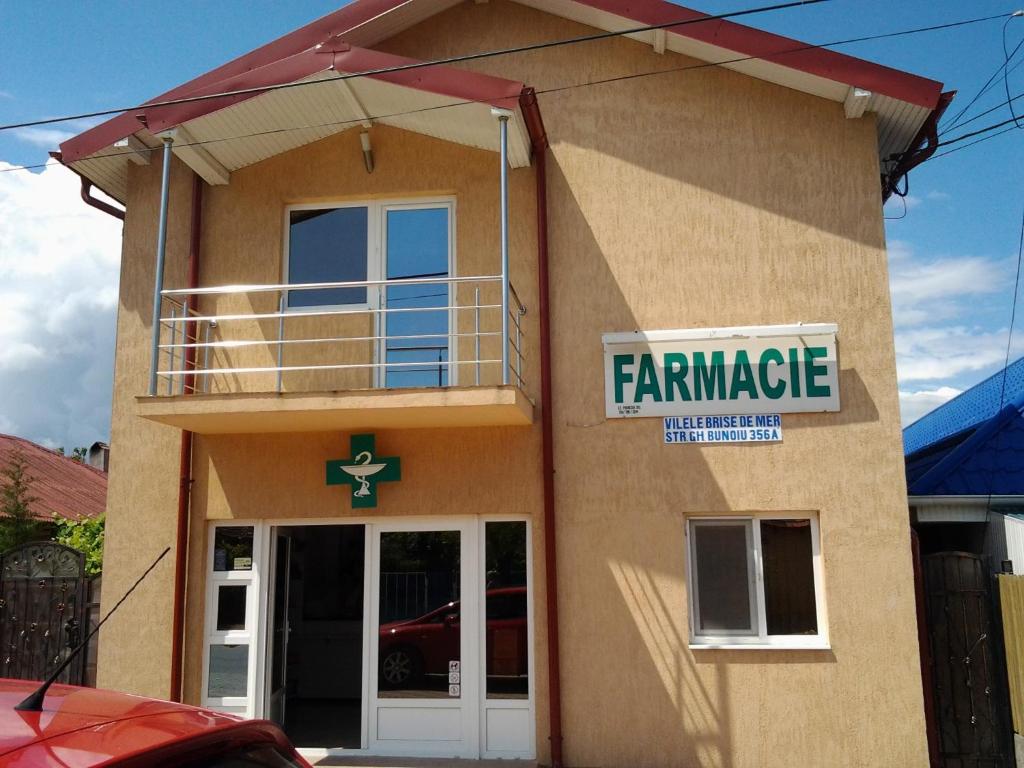 a building with a farmers market sign on it at Vilele Brise de Mer in 2 Mai