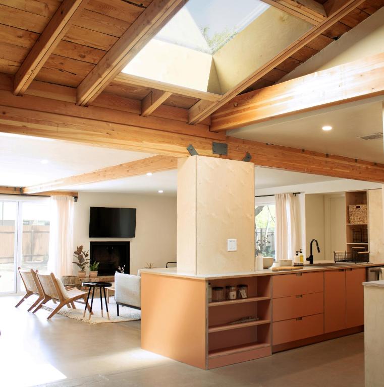 an open kitchen and living room with a skylight at Sonoran Peach - Light-Filled 5BR near TMC in Tucson